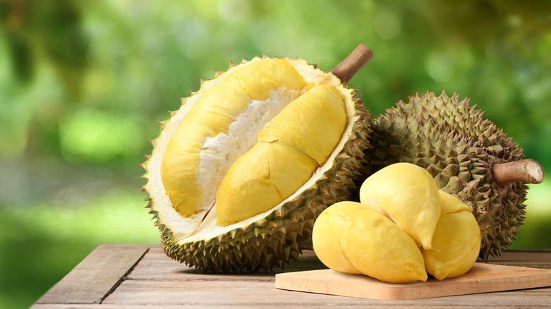 Durian fruit on wooden table outdoors