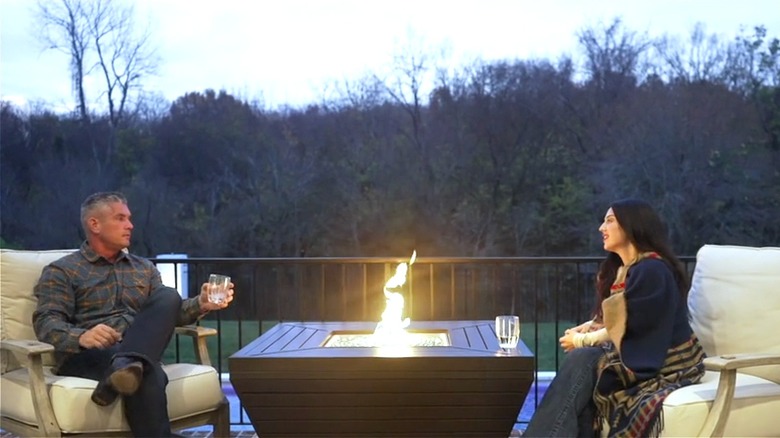 Couple sitting in front of the Sunbeam Contemporary Aluminum Fire Table