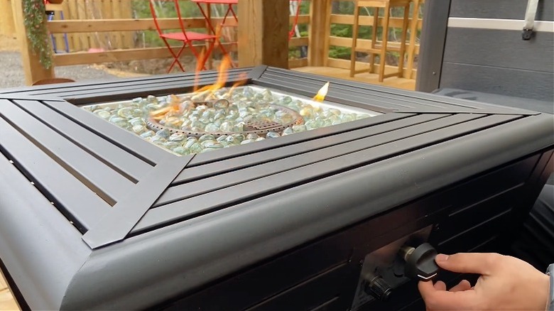 Sunbeam fire table in use, showing flames and control