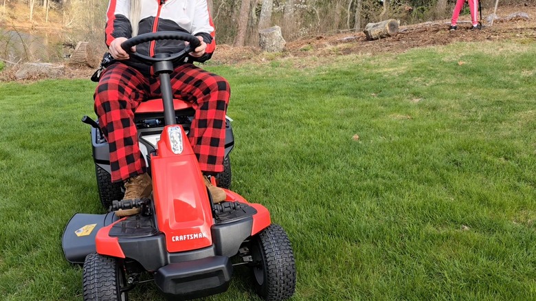 Person on Craftsman electric riding mower in yard