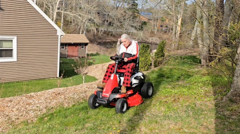 Person on Craftsman electric riding mower in yard