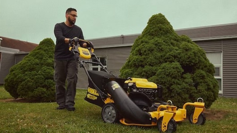 Man mowing lawn with DeWalt mower