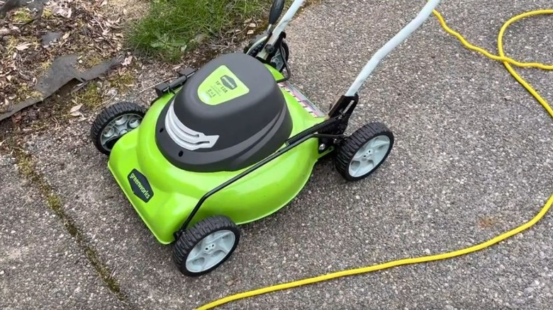 Greenworks 18-inch electric corded mower on a sidewalk