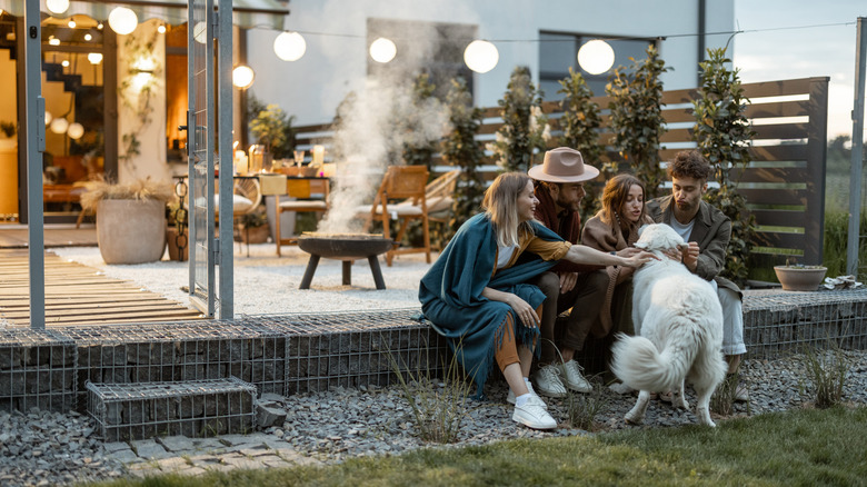 people sitting on patio with furniture in background