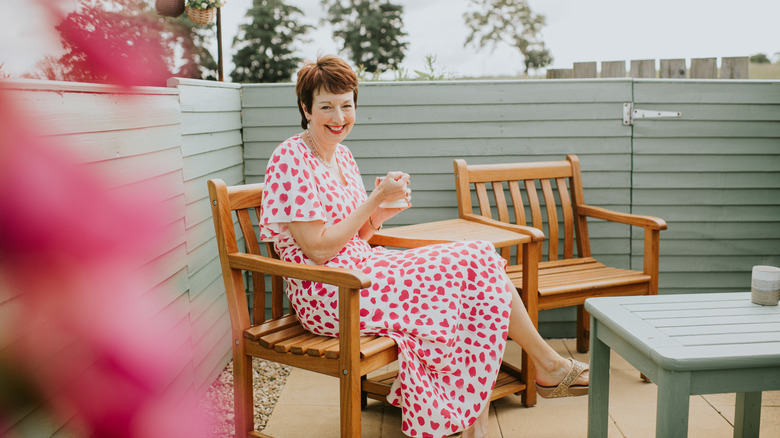 woman sitting on small patio