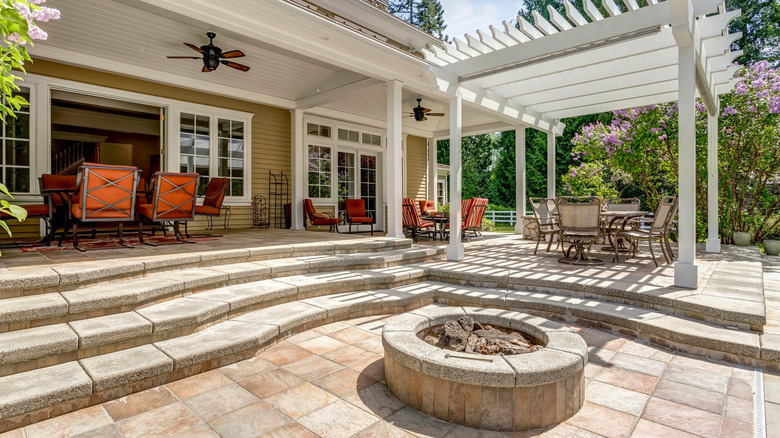 gorgeous paver patio with fire pit and pergola