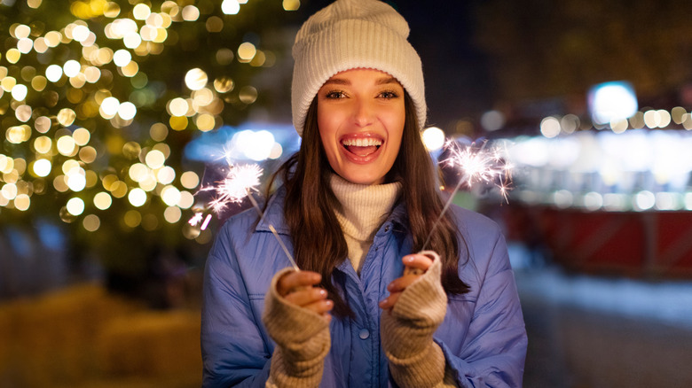 Woman with sparklers at New Year's