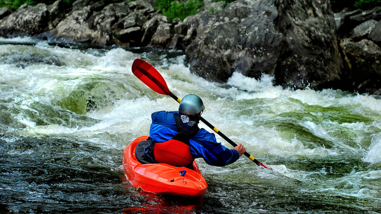 Kayaker bracing in whitewater