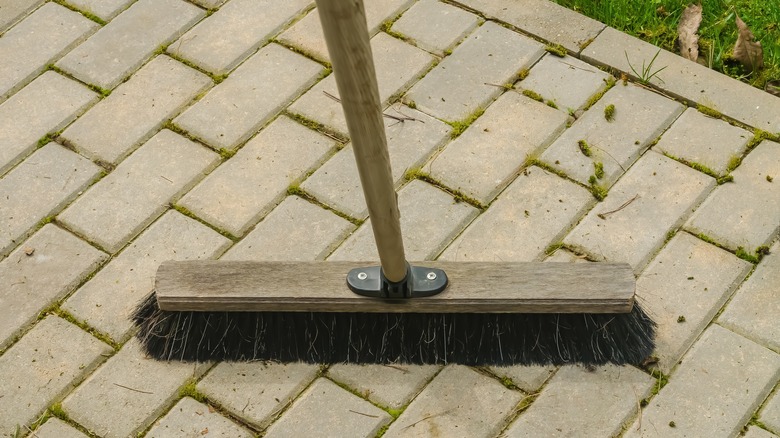 Sweeping debris off a brick patio