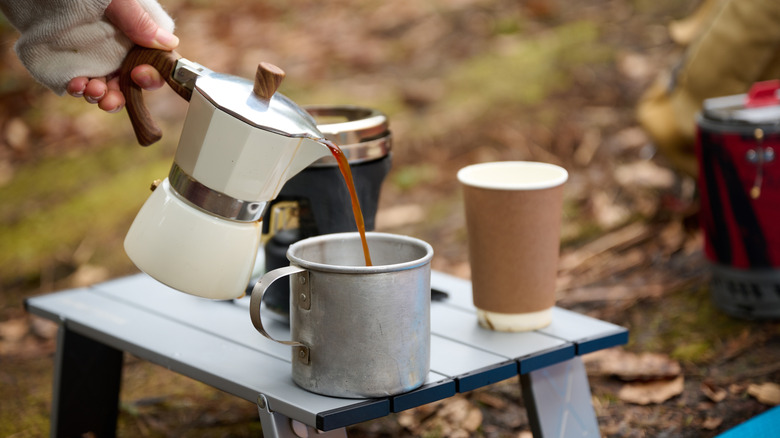 Pouring coffee outdoors at campsite