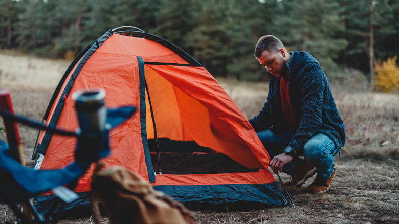 man setting up tent