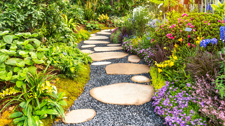 Colorful flowers bloom around a garden path
