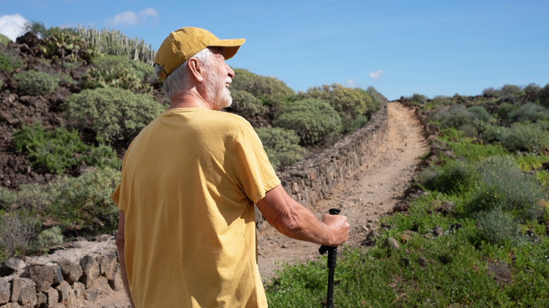 Smiling man hiking on a clear, sunny day