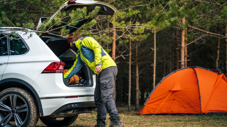 Man unloading the car on a camping trip