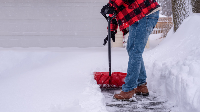 Person shoveling snow on a driveway