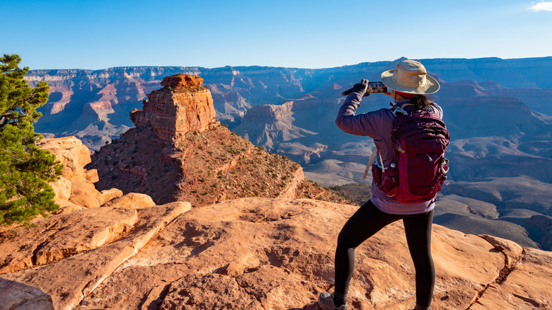 Woman taking picture at Grand Canyon