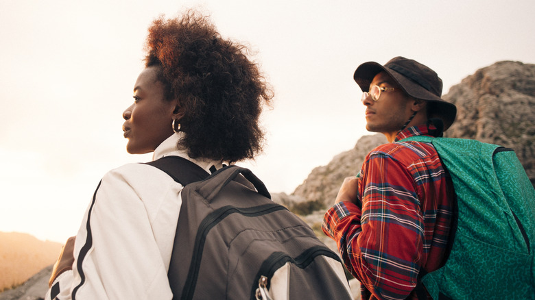 two hikers enjoy a view