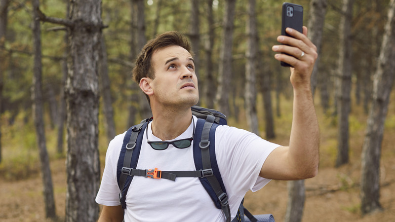 Hiker looking for a cell phone signal