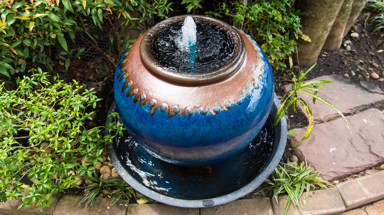 Small ceramic water feature in a garden