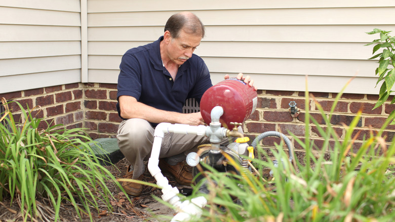 Person working on outdoor water well