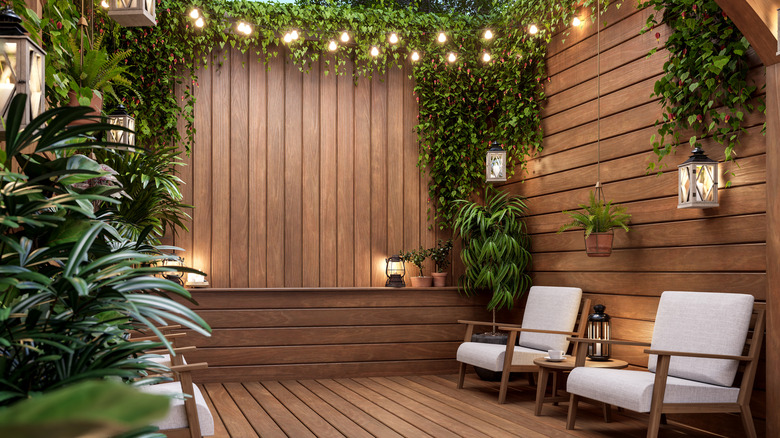 A contemporary wooden terrace with beautiful lanterns and festoon lights