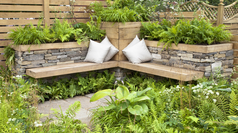 Wooden benches built into an existing stone wall