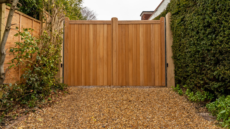 Wooden gate and gravel driveway