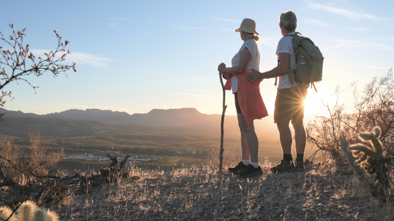 Two hikers in shorts looking at the sun