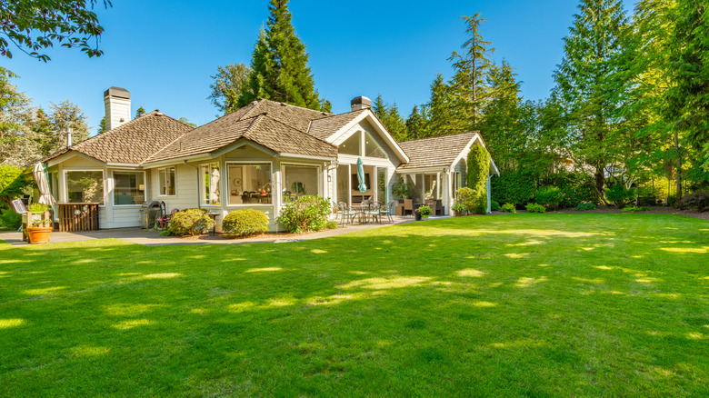 A white house with a large lawn