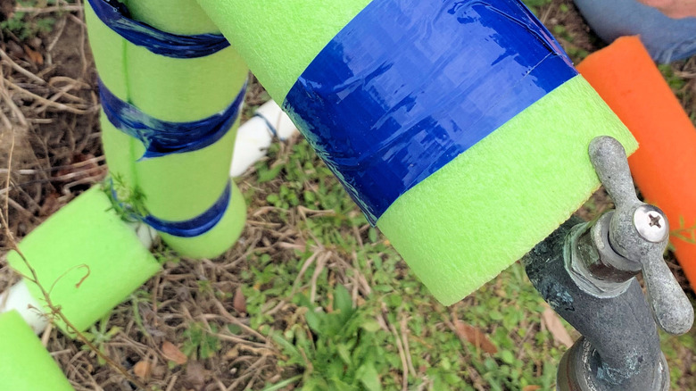 outdoor pipes wrapped in foam pool noodles