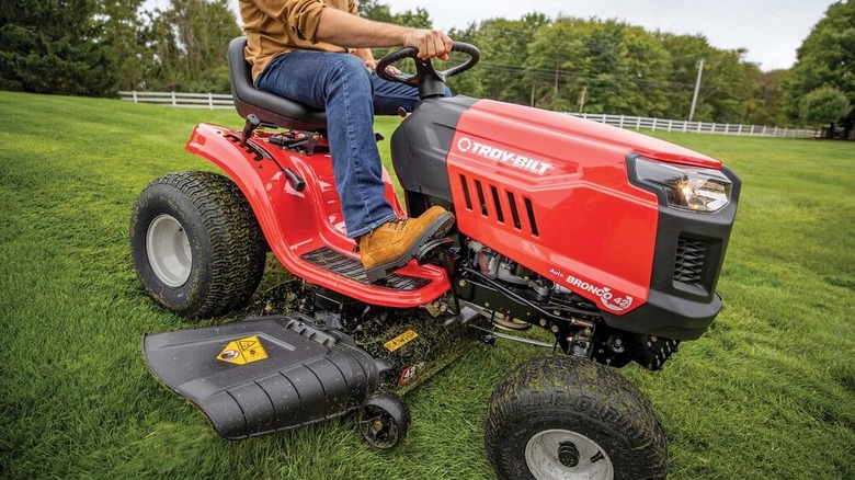 A man on a Troy-Bilt tractor mower