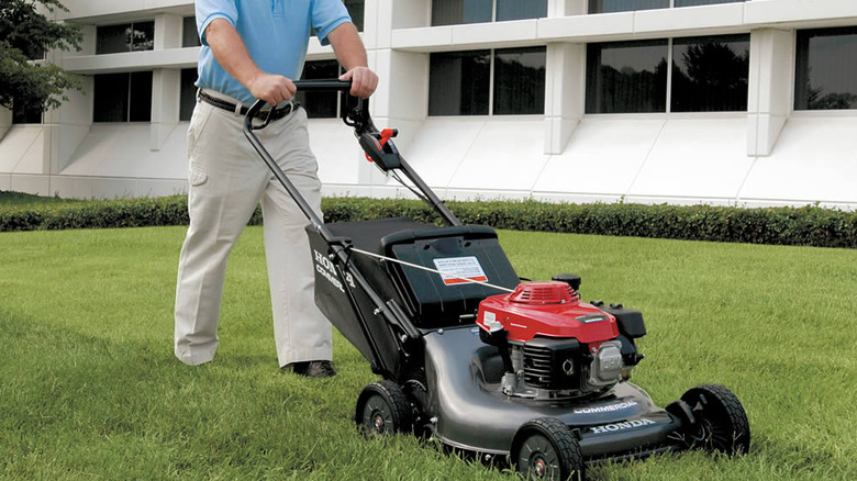 A man pushing a Honda push mower