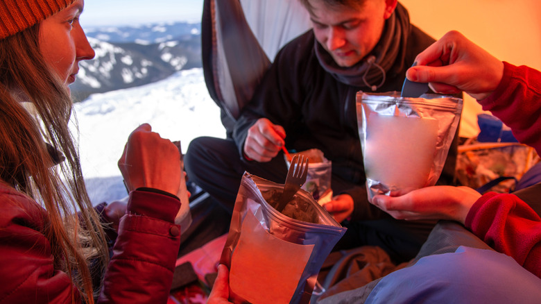 Campers inside tent in winter