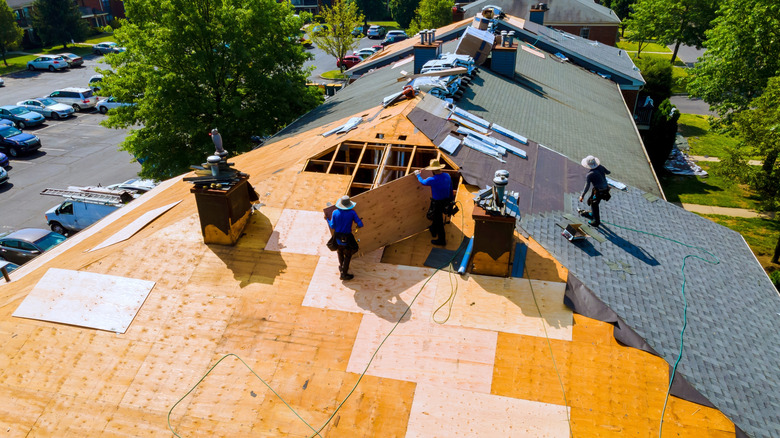 Workers replacing a roof