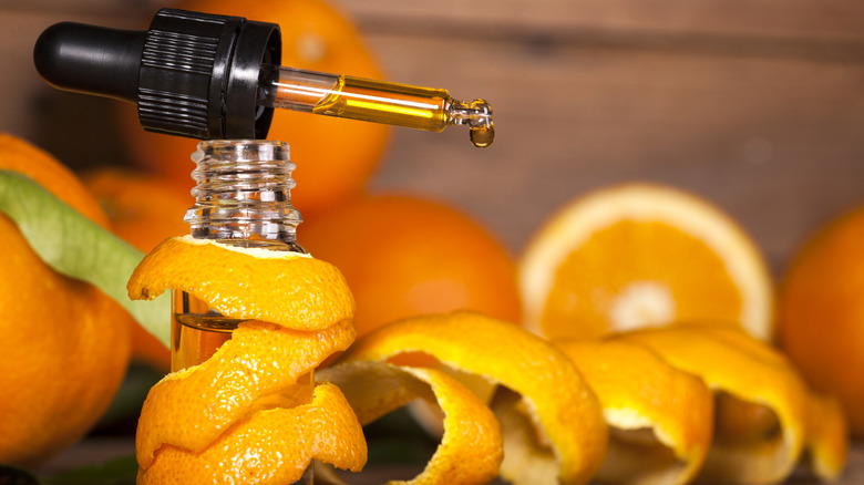 Orange essential oil and oranges
