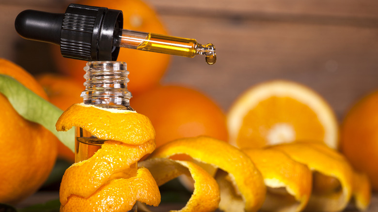 Orange essential oil and oranges