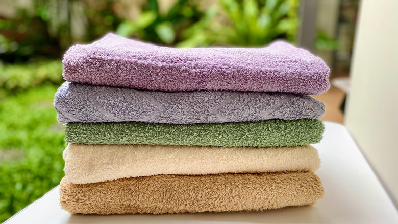 towels folded in a stack and sitting outside