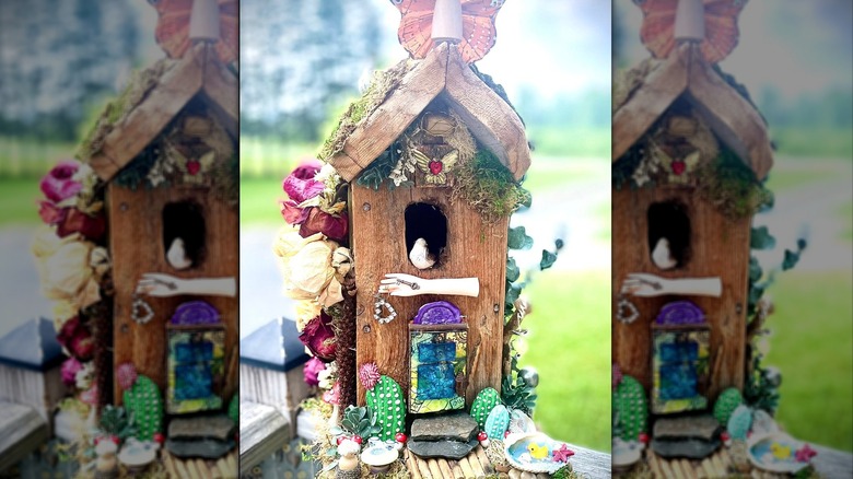 A fairy garden display built into a birdhouse