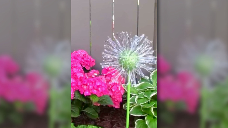 Upcycling trash into oversized flower decorations for a garden