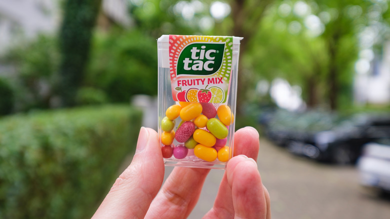 Tic Tac container in someone's hands outside