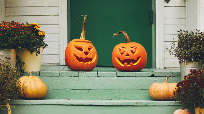 Jack-o-lanterns and pumpkins on porch