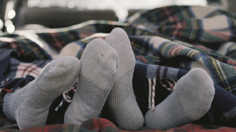 Two people sleeping in a car in winter