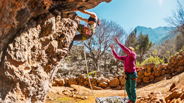 Rock climber practicing falling with partner