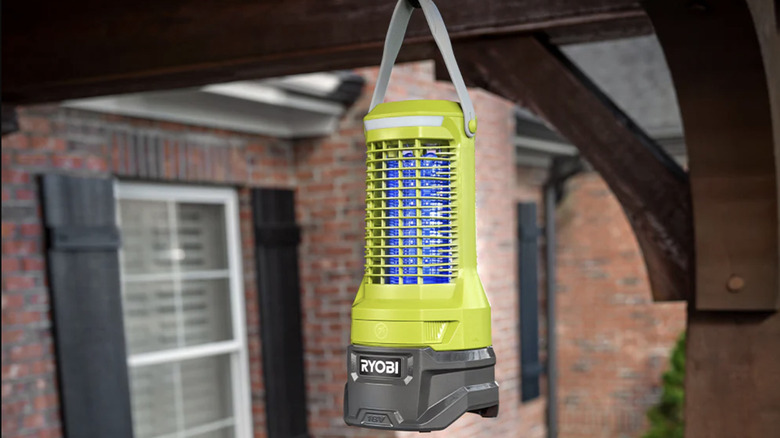 A Ryobi 18V ONE+ bug zapper hanging near a home