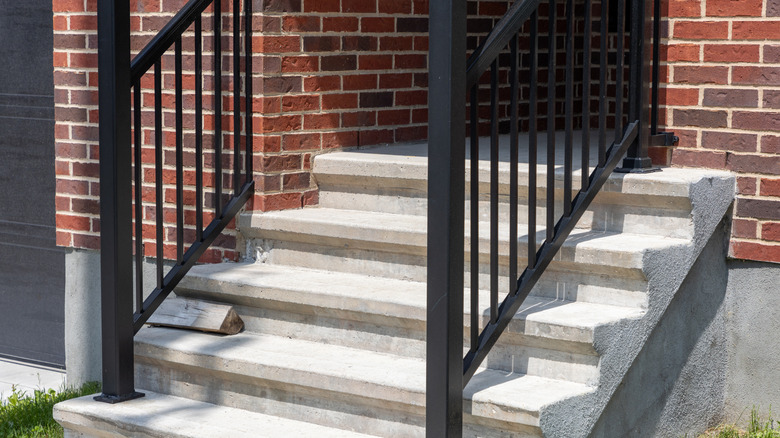 Concrete stairs leading into a brick building