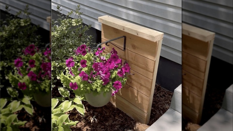 DIY wood hose screen with hanging flowerpot