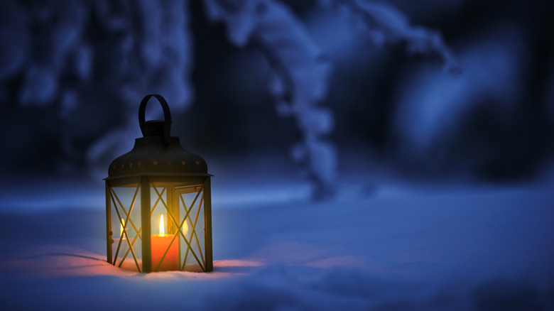 Traditional candle lantern in snow