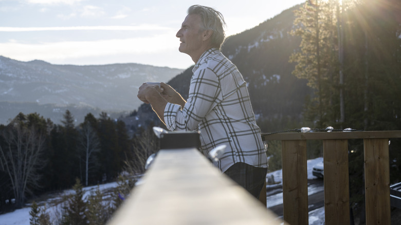 Man warm on his balcony in the snow