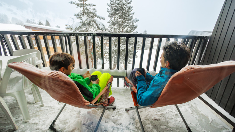 Two kids on a balcony in winter