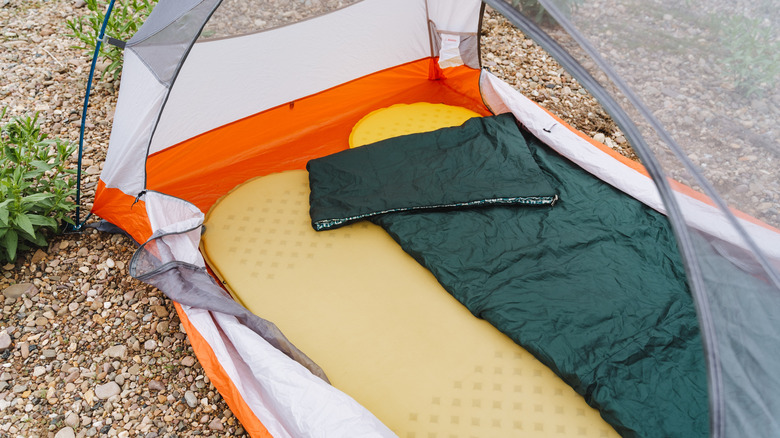 sleeping bag on top of pads in small tent